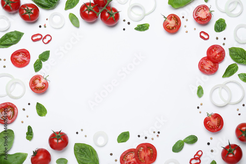 Frame made of fresh basil leaves and vegetables on white background, top view. Space for text