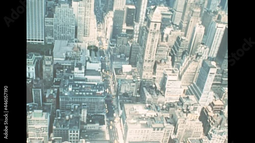 Midtown Manhattan on Bryant Park of New York with historic buildings on road traffic. Archival skyline of New York with Roosevelt Island on East river in 70s. Vintage United States of America in 1976.