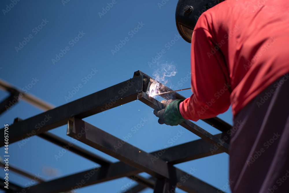 Worker welding the roof steel in construction site, Close up. Worker welding the roof steel in construction site, Close up.