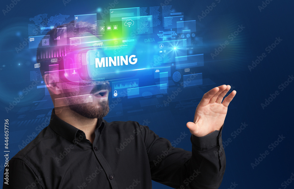 Businessman looking through Virtual Reality glasses Businessman looking through Virtual Reality glasses