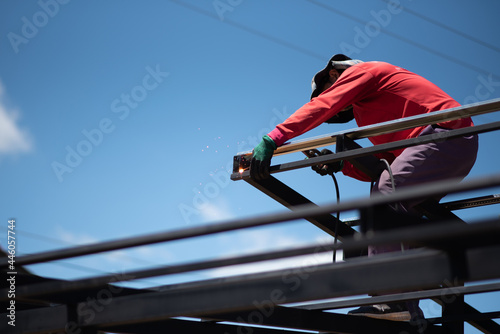 Worker welding the roof steel in construction site, Close up.