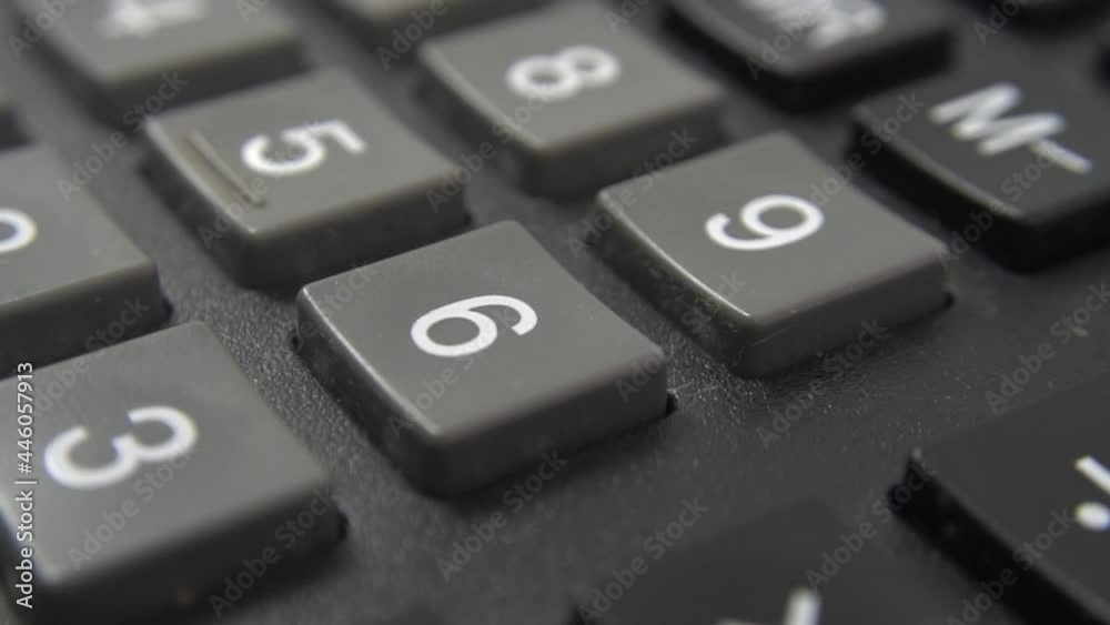 Calculator keyboard close up view. Black calculator buttons, selective focus. A heavily used old accounting engineering calculator with dirt between buttons. Dolly shooting. Calculator keyboard close up view. Black calculator buttons, selective focus. A heavily used old accounting engineering calculator with dirt between buttons. Dolly shooting.