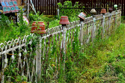 wrought iron fence and ceramic pots
