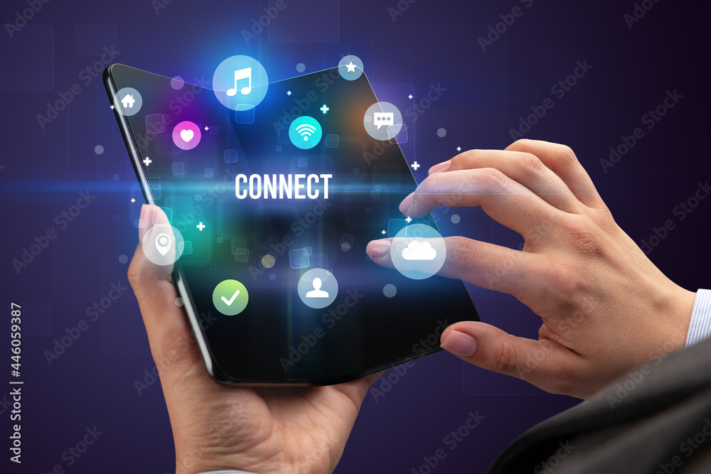 Businessman holding a foldable smartphone Businessman holding a foldable smartphone
