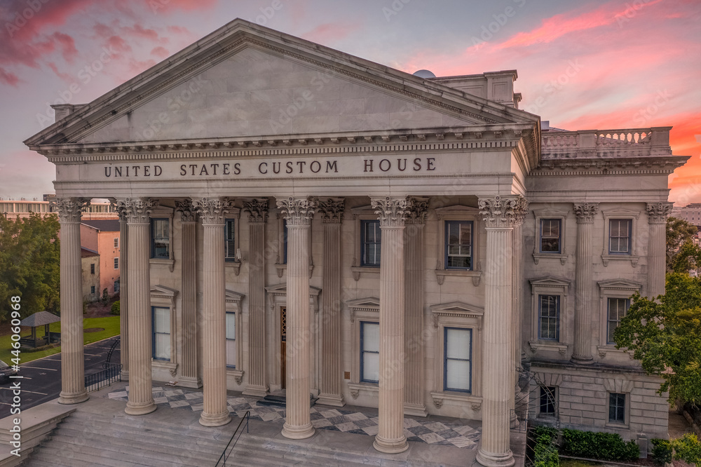 Sunset aerial view of old custom house with classical Greek style columns in the historic center of Charleston South Carolina orange, red dramatic sky background Sunset aerial view of old custom house with classical Greek style columns in the historic center of Charleston South Carolina orange, red dramatic sky background
