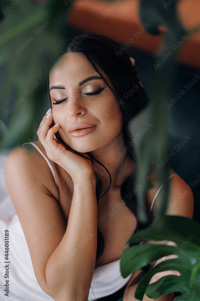 morning of the bride. beautiful brunette on her wedding day is going to the exit to the altar. in a beautiful negligee morning of the bride. beautiful brunette on her wedding day is going to the exit to the altar. in a beautiful negligee