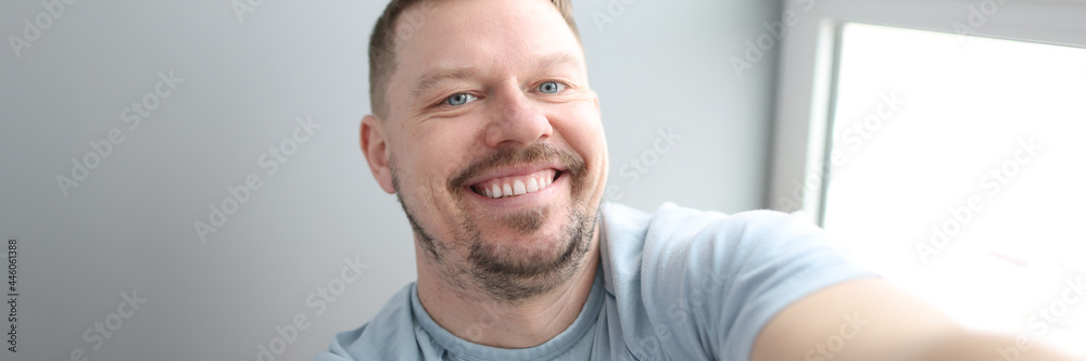Young smiling man taking selfie at home Young smiling man taking selfie at home