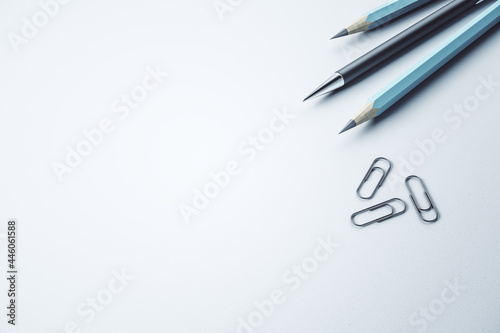 Close up of pencils and paper clips on white mockup desk backdrop, Stationery concept. 3D Rendering.