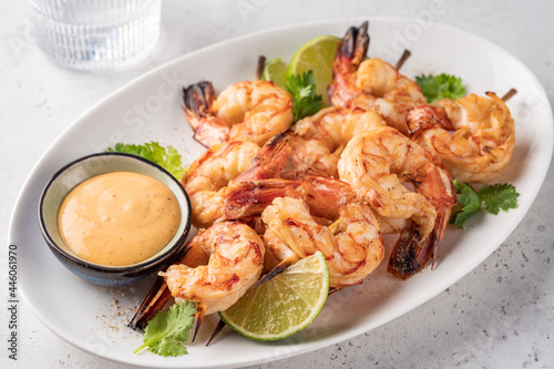Grilled shrimps. Shrimps skewers, lime and sauce