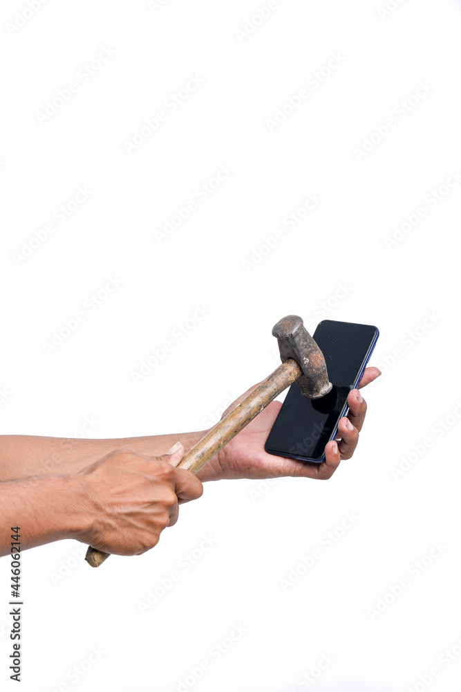 A man is breaking a smartphone with a big hammer A man is breaking a smartphone with a big hammer