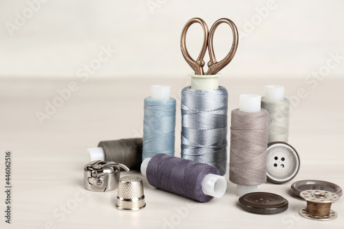 Composition with different sewing items on light beige table