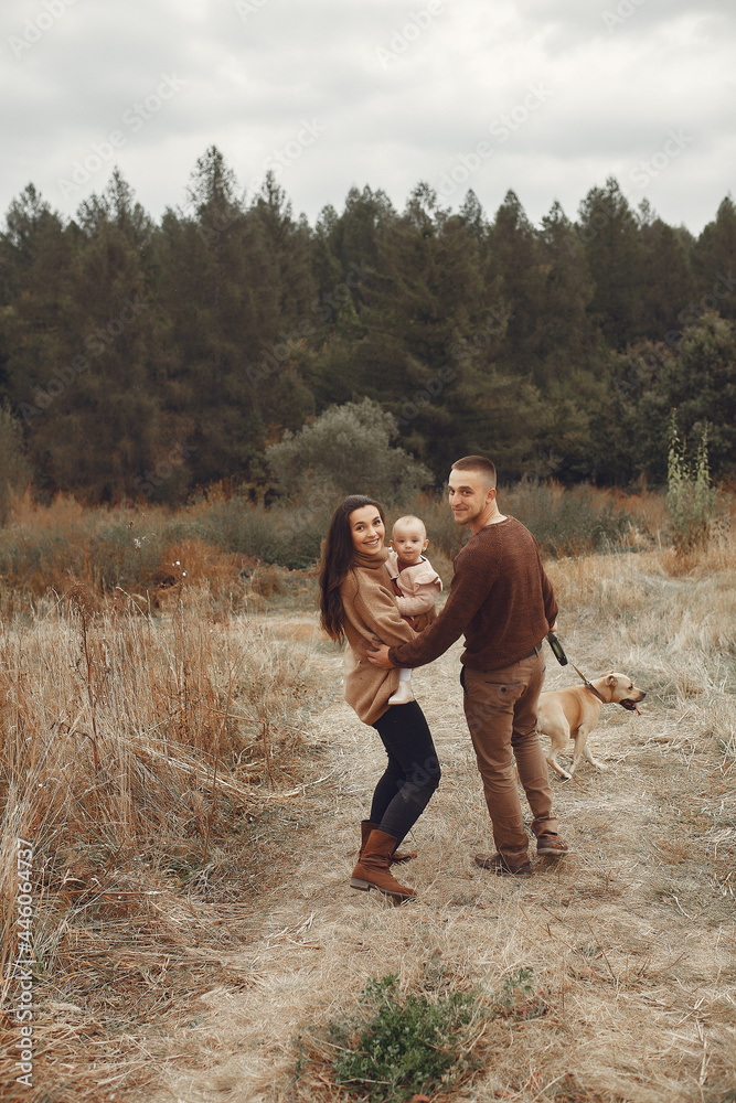 Cute and stylish family playing in a autumn field Cute and stylish family playing in a autumn field