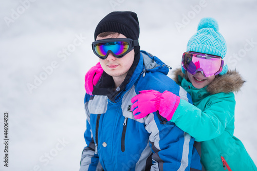 Happy couple of skier and snowboarder having fun at the ski resort. Father and daughter at the ski resort. Ski winter sports concept