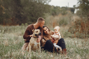 Cute and stylish family playing in a autumn field