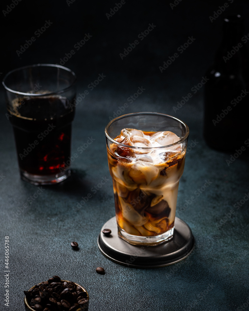 Ice coffee in a tall glass with cream poured over. almond milk latte. Cold summer drink. Cold brew in glass. vegetarian coffee in glass. Vietnamese Iced Coffee. vegan latte Ice coffee in a tall glass with cream poured over. almond milk latte. Cold summer drink. Cold brew in glass. vegetarian coffee in glass. Vietnamese Iced Coffee. vegan latte