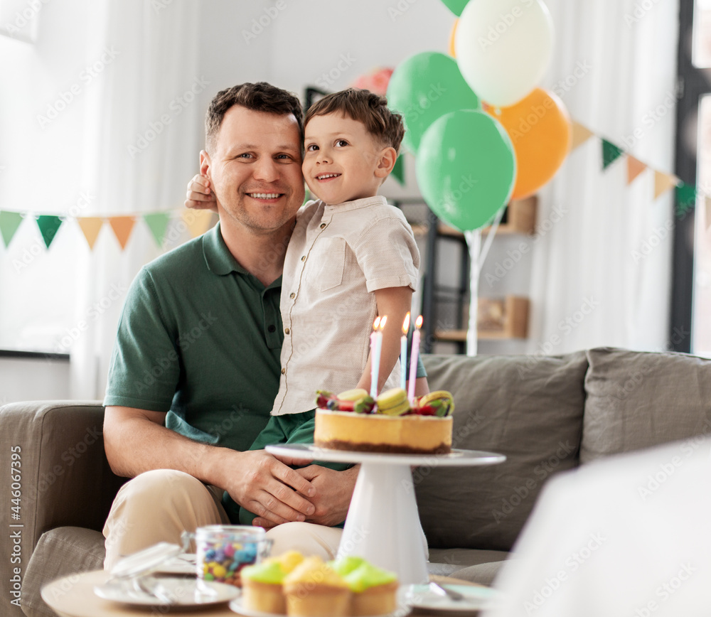 family, holidays and people concept - portrait of happy father with little son at home birthday party