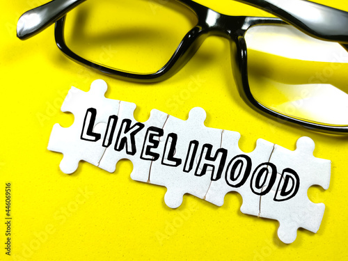 Text LIKELIHOOD on jigsaw puzzle with glasses on a yellow background.