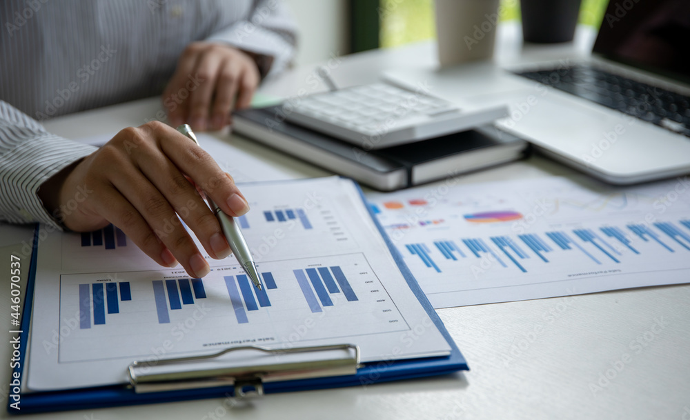 Business asian woman working with financial data hand using calculator and laptop to calculate investment results, Business reports financial and accounting concept, Business asian woman working with financial data hand using calculator and laptop to calculate investment results, Business reports financial and accounting concept,