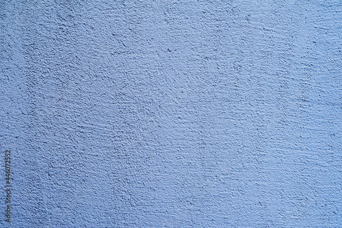 Colored plastered wall of blue color. Modern background