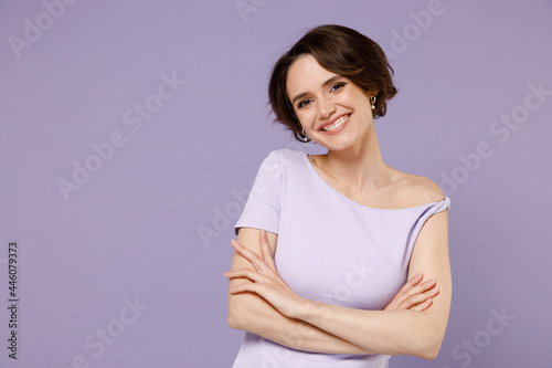 Obraz na plátně Young cheerful smiling happy stylish brunette woman 20s with bob haircut wearing white t-shirt hold hands crossed folded isolated on pastel purple background studio portrait