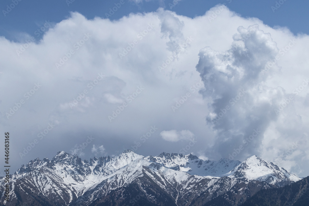 Huge clouds over mountain snowy peaks Huge clouds over mountain snowy peaks