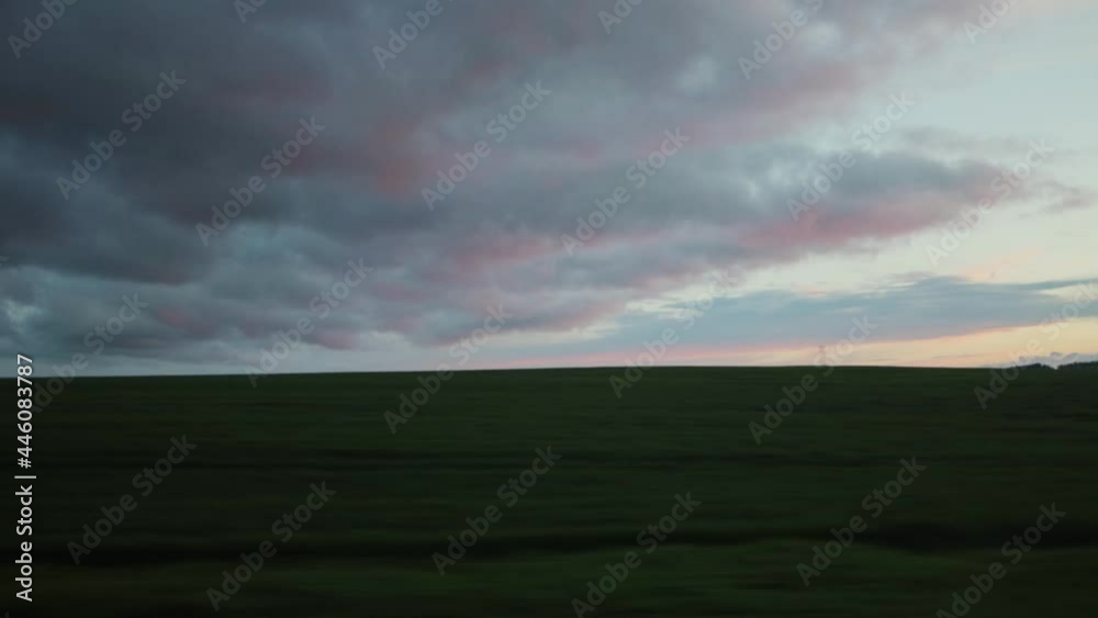 View from the car window on a trip. Evening beautiful sky and fields with grass. Copy space for text, landscape View from the car window on a trip. Evening beautiful sky and fields with grass. Copy space for text, landscape
