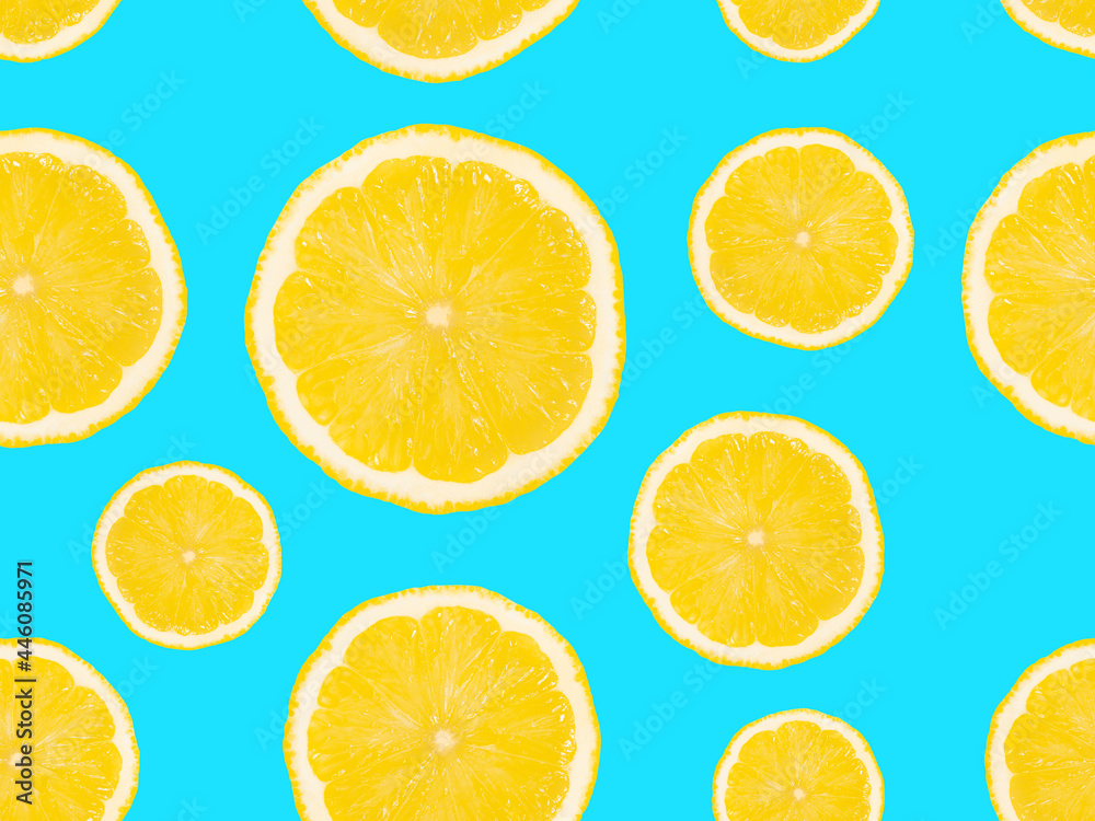Slices of lemons on a blue background. Seamless pattern.