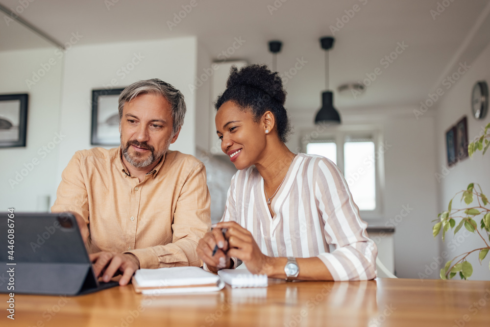 Adult husband, showing their pictures to his black wife. Adult husband, showing their pictures to his black wife.