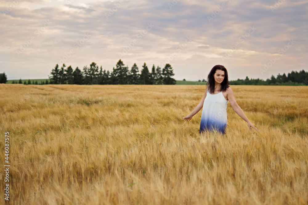 Portrait of young pretty woman without bra in barley field