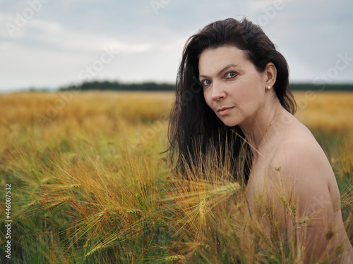 Konstfotografi Portrait of young pretty woman without bra in barley field