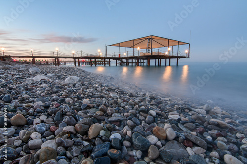Close up of pier on the sea beach shot with long exposure at dusk time.  © kyrychukvitaliy