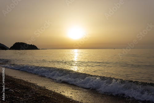 Beautiful view of seaside at dawn. Sunrise view with waves and sea. Landscape of rising sun over the sea in Cirali  Antalya  Turkey.