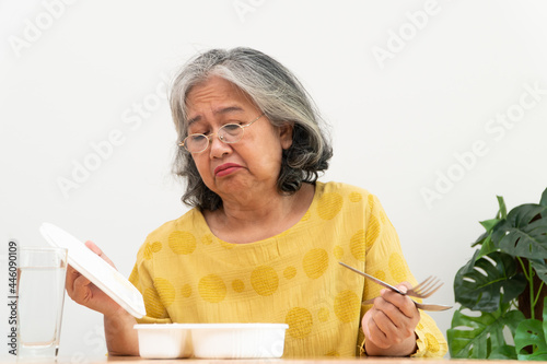 Fotografia Unhappy Asian senior woman anorexia and say no to ready meals, Elderly home alon