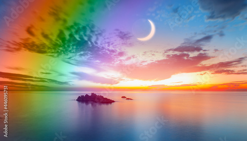 Dusk rainbow concept - Beautiful landscape with multi colored calm sea with double sided rainbow at dusk © muratart