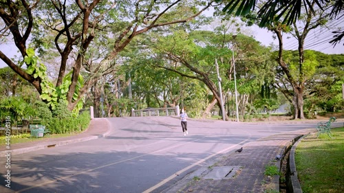 Wallpaper Mural A woman is running in the garden road. (wide shot) Torontodigital.ca