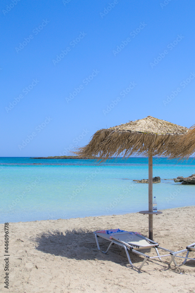Sun lounger and parasol on a beautiful sandy beach.