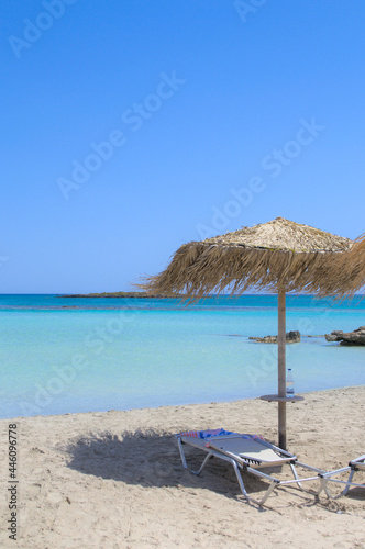 Sun lounger and parasol on a beautiful sandy beach.