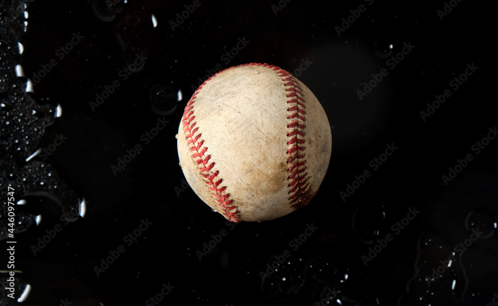 Old sports banner with used baseball ball in dark black water background. Old sports banner with used baseball ball in dark black water background.