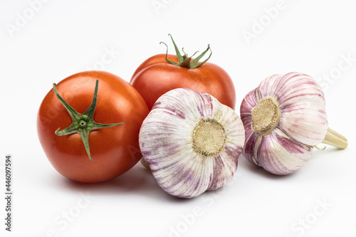 Tomatoes and garlic isolated on a white background.