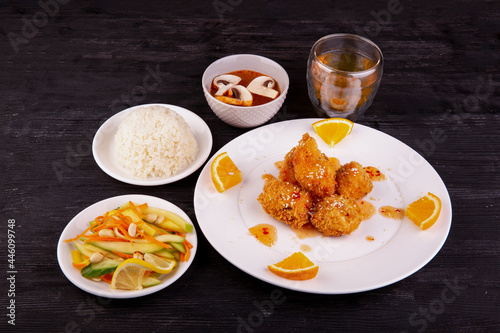 complex lunch with fried chicken in orange sauce