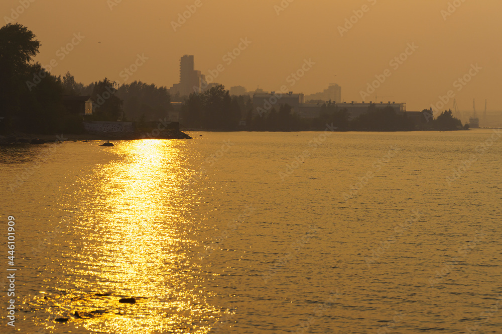 Fototapeta premium Forest fires smoke shrouded lake coast of city in summer day
