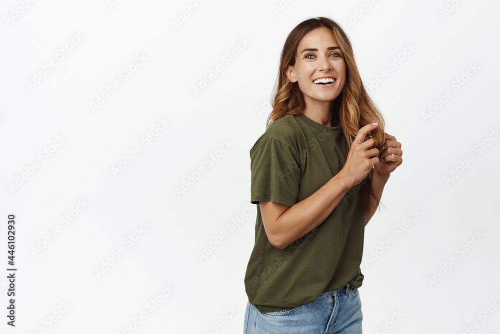 Beautiful middle aged woman with long healthy hair, smiling white teeth, laughing and looking happy at camera, wear casual t-shirt with jeans, studio background Beautiful middle aged woman with long healthy hair, smiling white teeth, laughing and looking happy at camera, wear casual t-shirt with jeans, studio background