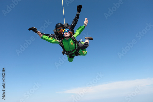 Skydiving. Tandem jump. Man and woman are in the sky.
