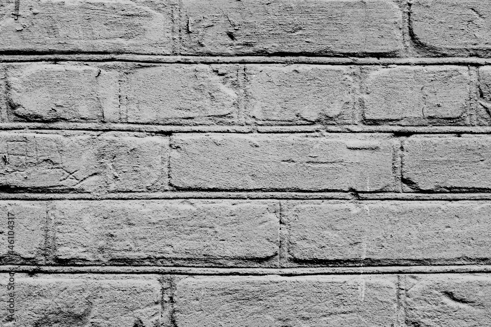 Texture of a brick wall with cracks and scratches which can be used as a background