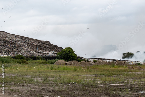 NOVOSIBIRSK, RUSSIA-17 July 2021:Fire at a household waste dump. Environmental pollution. Poisonous substances of dioxins enter the air when they enter the body and lead to gene mutations and tumors photo