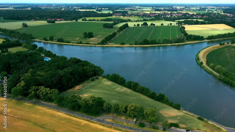Aerial view of the flight over the canal with an arch bridge whose iron arch is painted pink Aerial view of the flight over the canal with an arch bridge whose iron arch is painted pink