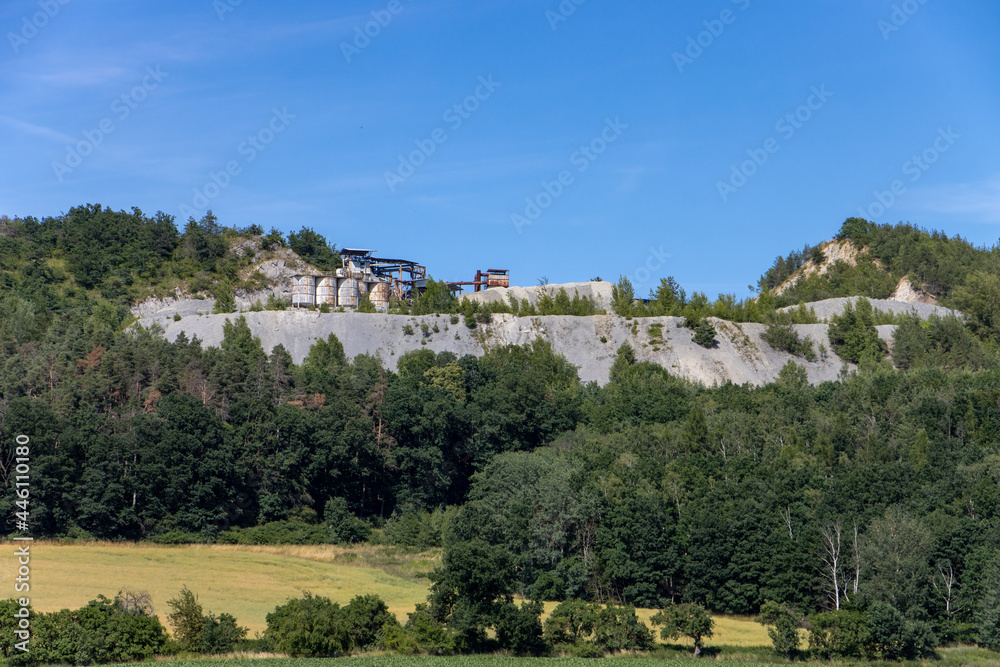 A quarry at the top of a mined hill
