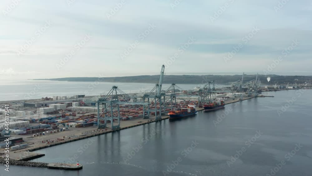 Container Shipyard on the Immense View Of the Ocean Waters and Pale Blue Skies Container Shipyard on the Immense View Of the Ocean Waters and Pale Blue Skies