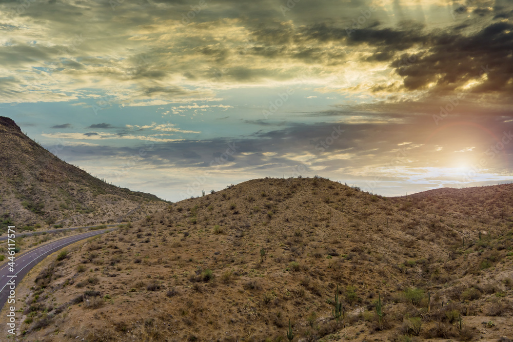 Fototapeta premium Aerial view adventure traveling desert road of the asphalt highway across the arid desert Arizona mountains