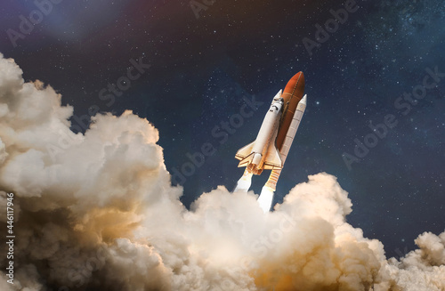 Fototapeta Naklejka Na Ścianę i Meble -  Space shuttle launch in the clouds to outer space. Dark space with stars on background. Sky and clouds. Spaceship flight. Elements of this image furnished by NASA